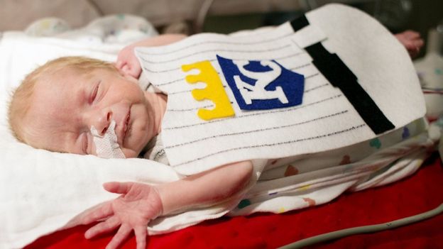 Baby in a Kansas City Royals baseball team outfit