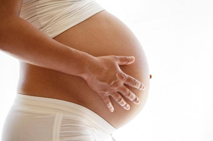 a pregnant women with her hands on her belly