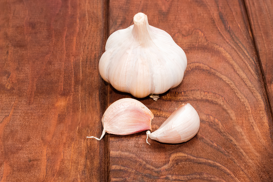 bigstock Garlic On A Wooden Surface Clo 117113795
