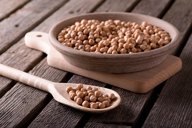 bigstock Wooden Spoon In Front Of Clay 128565632