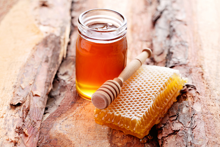 bigstock jar of honey with honey comb 92166464