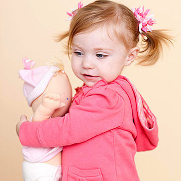 toddler hugging doll