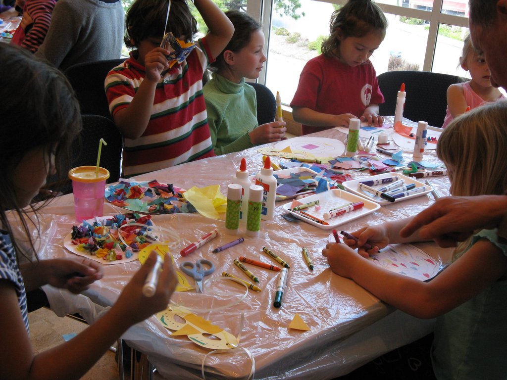 Cover the arts and crafts workspace with paper, a plastic tablecloth, or plastic wrap for easy cleanup.