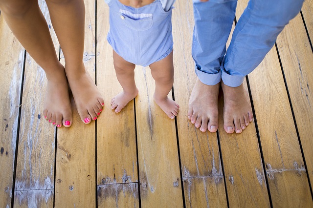 bigstock Baby firsts steps holding his 119900018