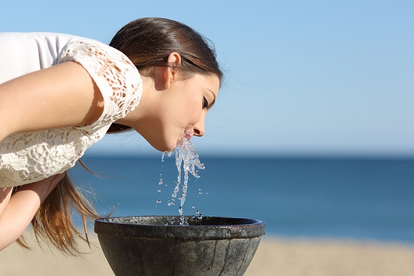 bigstock Woman Drinking Water From A Fo 85984196
