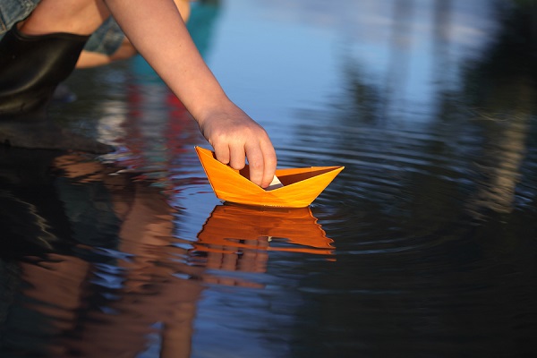 bigstock paper ship in children hand 35473901