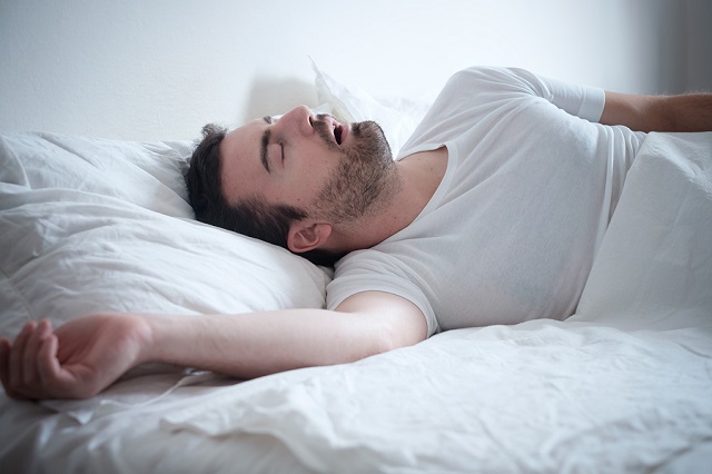 bigstock Man Sleeping In His Bed And Sn 148914881