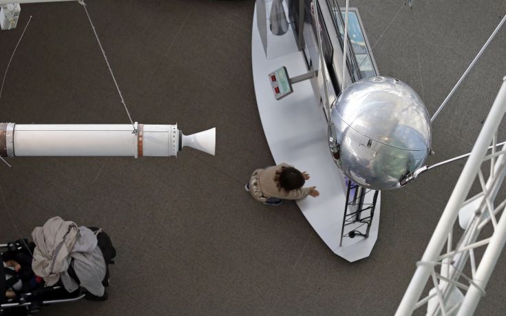A child climbs below a Sputnik 1 test satellite, right, most likely manufactured by the Academy of Sciences of the USSR and one of only two known to exist, on display at the Museum of Flight, Monday, Oct. 2, 2017, in Seattle. At left is a full-size model of Explorer 1, a U.S. satellite developed in response to the Soviet satellite and launching the space race. Sixty years earlier, the Soviet Union launched Sputnik 1, the world's first artificial satellite, aboard an R-7 intercontinental ballistic missile on October 4, 1957. According to Soviet calculations, the satellite traveled at 18,000 miles per hour, and its radio signals were picked up by scientists and ham radio operators throughout the world. Sputnik 1 orbited about 37 million miles, then burned up as it fell from orbit during reentry into Earth's atmosphere on January 4, 1958. (AP Photo/Elaine Thompson)