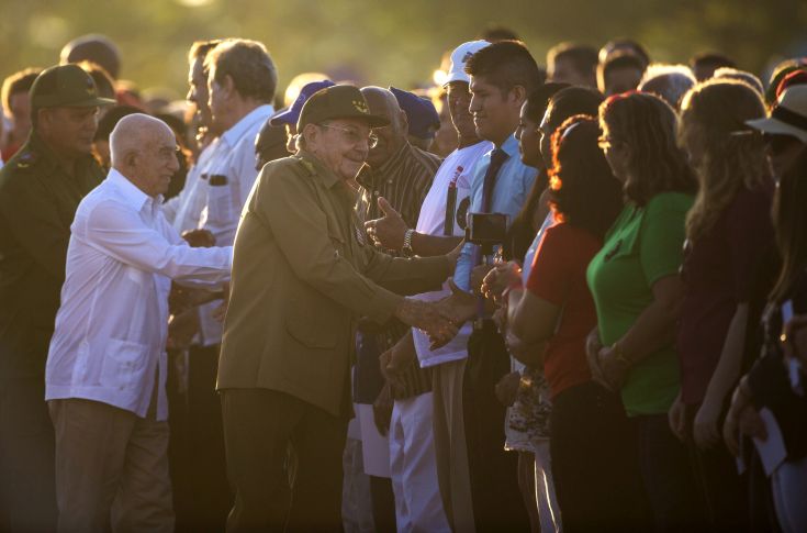 Cuba's President Raul Castro salutes people before the start of an event paying tribute to Cuban Revolution hero Ernesto “Che” Guevara marking the 50th anniversary of his death in Santa Clara, Cuba, Sunday, Oct. 8, 2017. (AP Photo/Desmond Boylan)