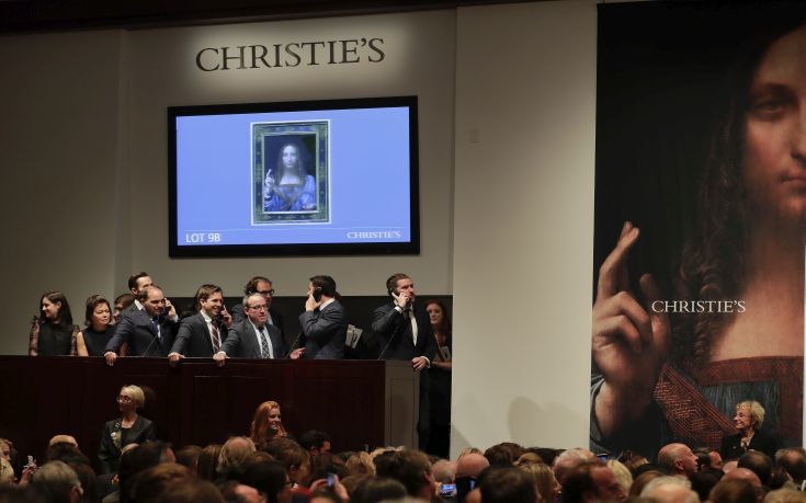 CORRECTS PRICE - Bidding representatives wait on phones for instructions from bidders for Leonardo da Vinci's "Salvator Mundi" at Christie's, Wednesday, Nov. 15, 2017, in New York. The painting sold for $450 million. (AP Photo/Julie Jacobson)