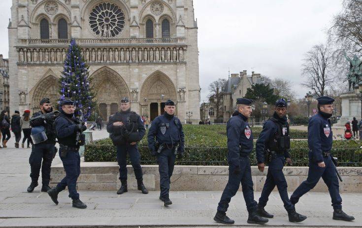 French police officers patrol in front of the Notre Dame cathedral in Paris, France, Sunday, Dec. 24, 2017. France's government is deploying nearly 100,000 police and soldiers for the holiday season as fears of extremist attacks remain high. (AP Photo/Michel Euler)