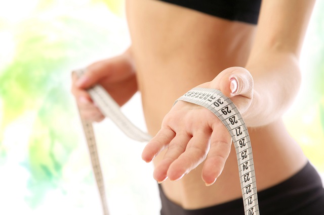bigstock A woman measuring her waist f 28165064