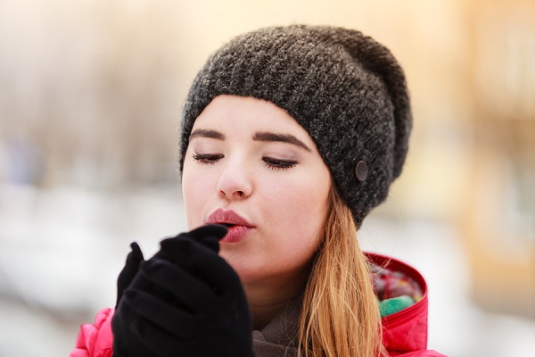 bigstock Woman During Winter Warming Up 214652143