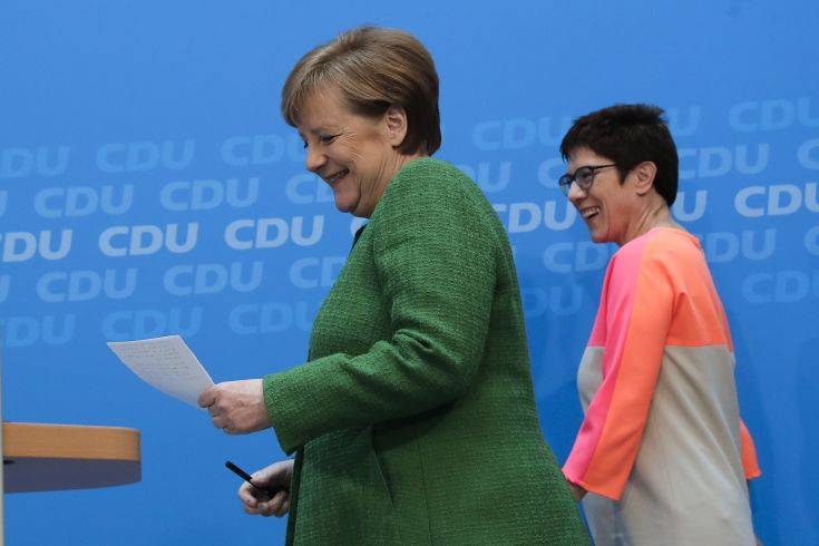 German Chancellor Angela Merkel, left, and the governor of German Saarland state and designated CDU Secretary General, Annegret Kramp-Karrenbauer, right,arrive at a news conference after a party's leaders meeting in Berlin, Germany, Monday, Feb. 19, 2018. (AP Photo/Markus Schreiber)