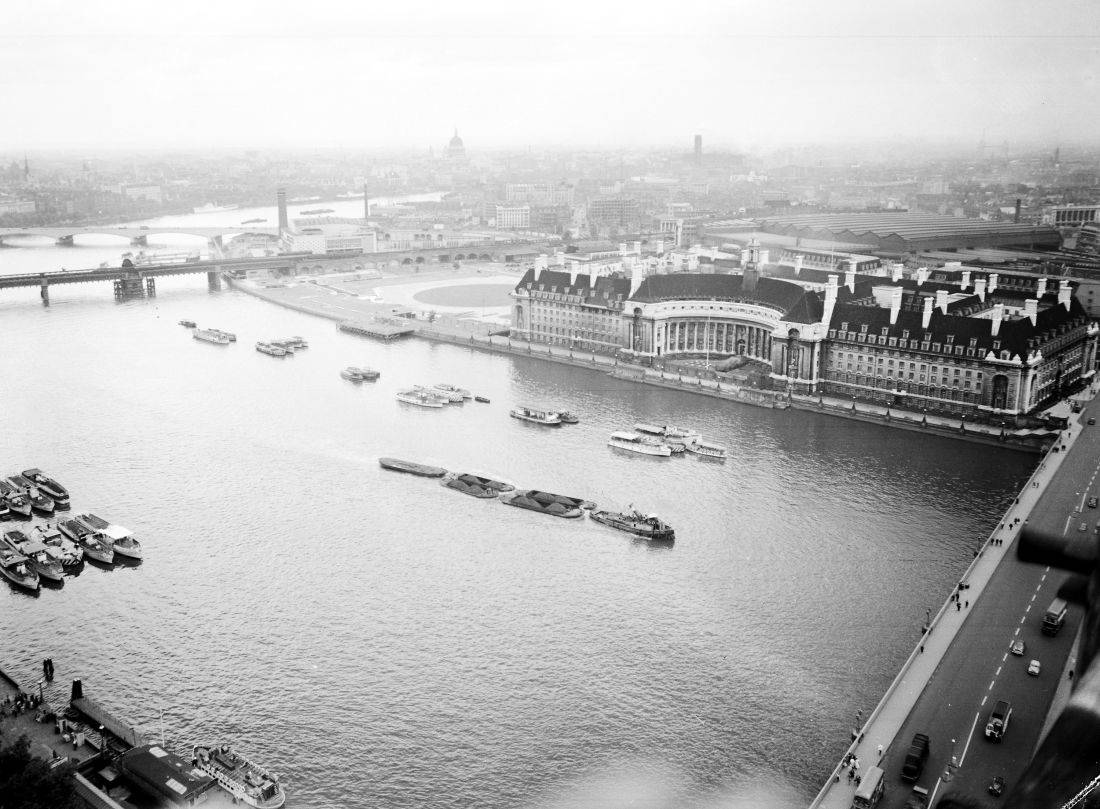 Picture taken from the top of 'Big Ben' clocktower of the Houses of Parliament, London, June 30, 1955. The bridge in right foreground is Westminster Bridge, the next bridge, centre left, is Hungerford Railway and Footpath Bridge and the next just above is Waterloo Bridge. The dome of St. Paul's Cathedral can be seen in the distance. The main building across the river is County Hall and just above that can be seen the huge roof of Waterloo Railway Station. (AP Photo/Staff/Worth)