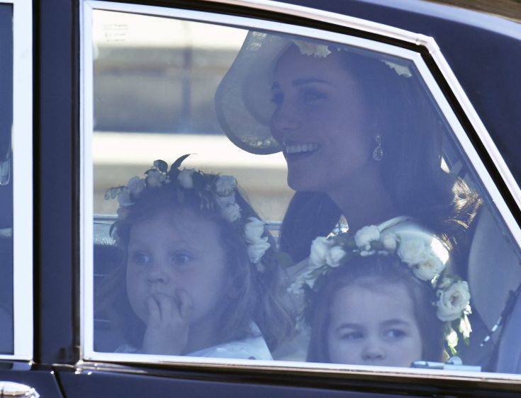 Kate, Duchess of Cambridge arrives with the Princess Charlotte, right, for the wedding ceremony of Prince Harry and Meghan Markle at St. George's Chapel in Windsor Castle in Windsor, near London, England, Saturday, May 19, 2018. (Ben Birchhall/pool photo via AP)