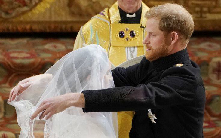Britain's Prince Harry removes the veil of Meghan Markle during their wedding ceremony at St. George's Chapel in Windsor Castle in Windsor, near London, England, Saturday, May 19, 2018. (Owen Humphreys/pool photo via AP)