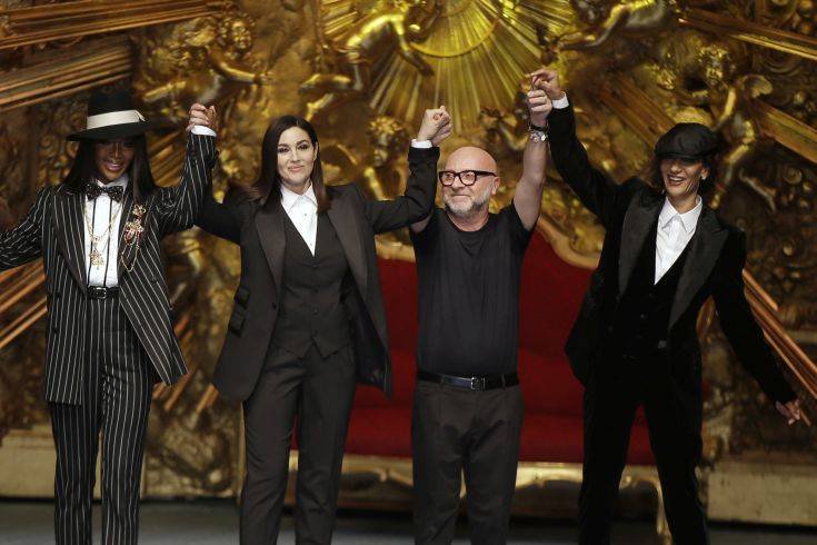 Model Naomi Campbell, from left, actress Monica Bellucci and designer Domenico Dolce accept applause at the end of Dolce & Gabbana's men's 2019 Spring-Summer collection, unveiled during the Fashion Week in Milan, Italy, Saturday, June 16, 2018. (AP Photo/Luca Bruno)
