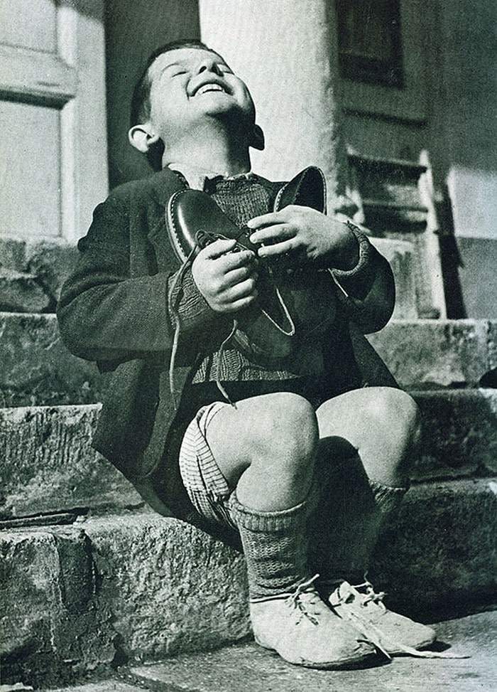 Austrian boy just got new shoes as a gift. The picture was taken during the Second World War