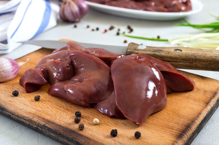 Raw Chicken Liver On A Cutting Board, Knife On The Table. Offal. Ready To Cook. Dishes From The Live