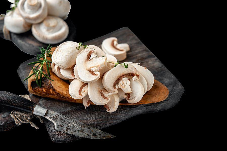 Natural, Organic Mushrooms On A Vintage Wooden Table. Sliced Slices Of Fresh Raw Mushrooms Porcini M