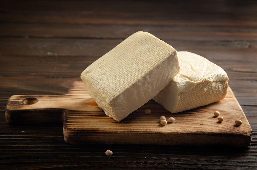 Soybean Tofu Vegetable Bean Curd On Cutting Board On Kitchen Table