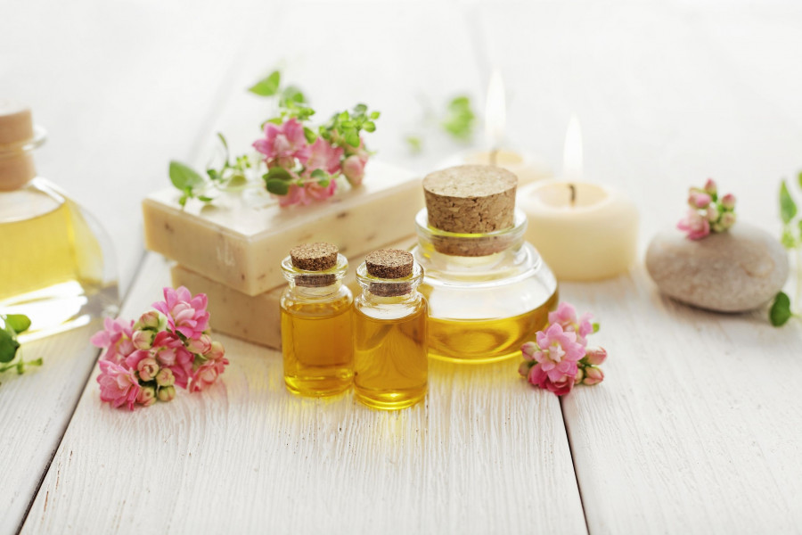 SPA still life. herbs, flowers, pebbles, aromatherapy candle, essential oil and bath products