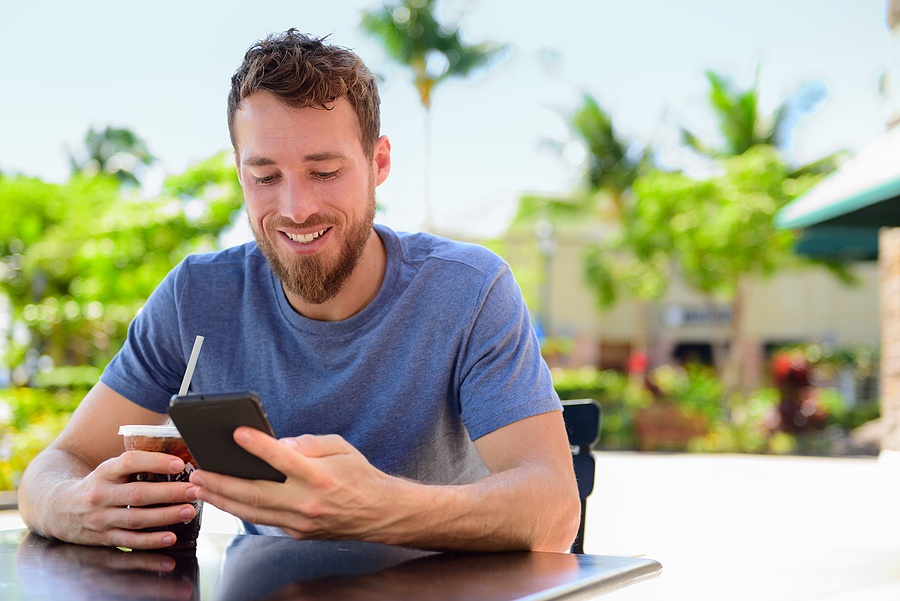 Smartphone man sms texting drinking cold coffee